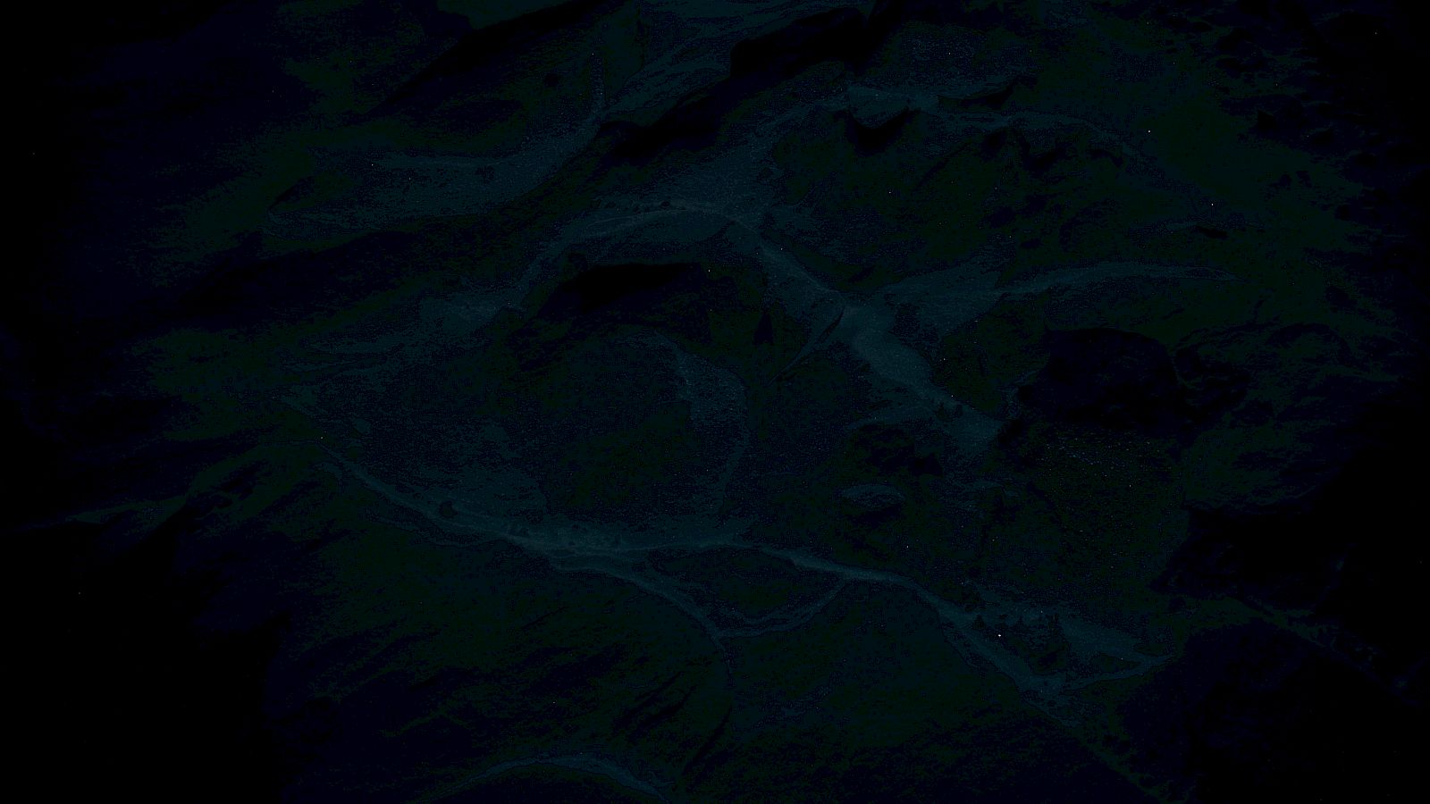 The image appears to be very dark with indistinct shapes or patterns, possibly an abstract design or a low-light scene.