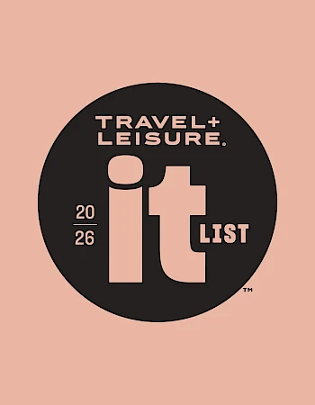 Travel + leisure logo in a black circle with peach text and &ldquo;2026&rdquo; on the left, on a peach background.